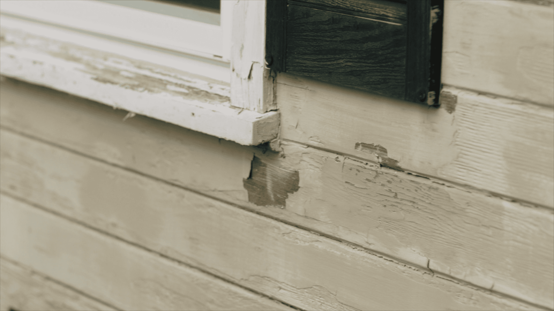 Decide to Re-side: Close-up on wood siding with chipped and peeling paint Close-up on wood siding with chipped and peeling paint
